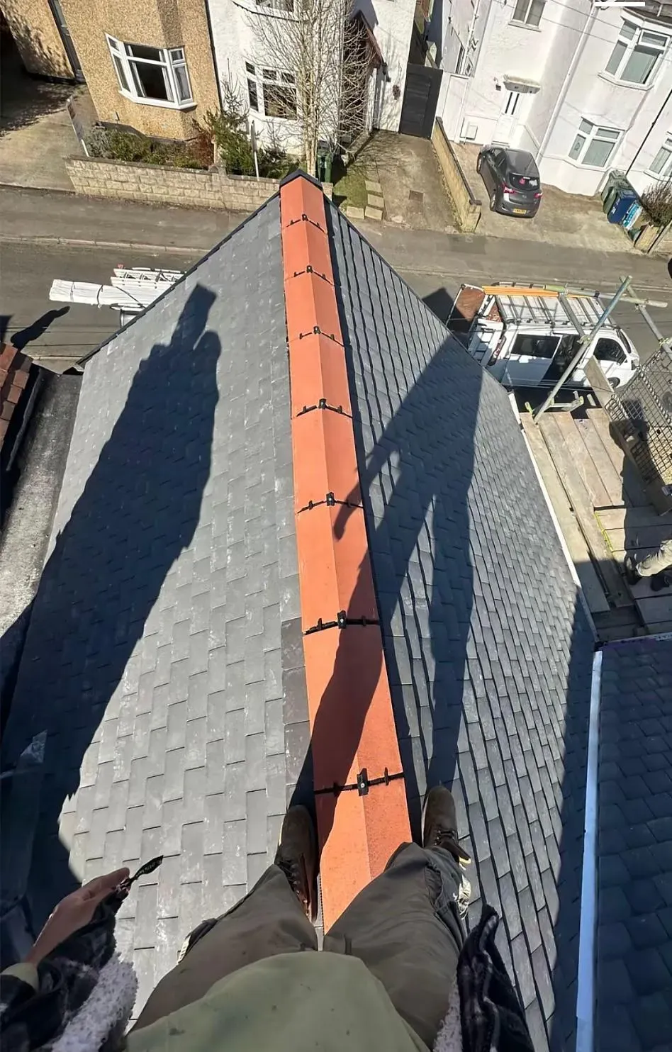 Roofer's eye view of a newly installed tiled roof with dry-ridge system.