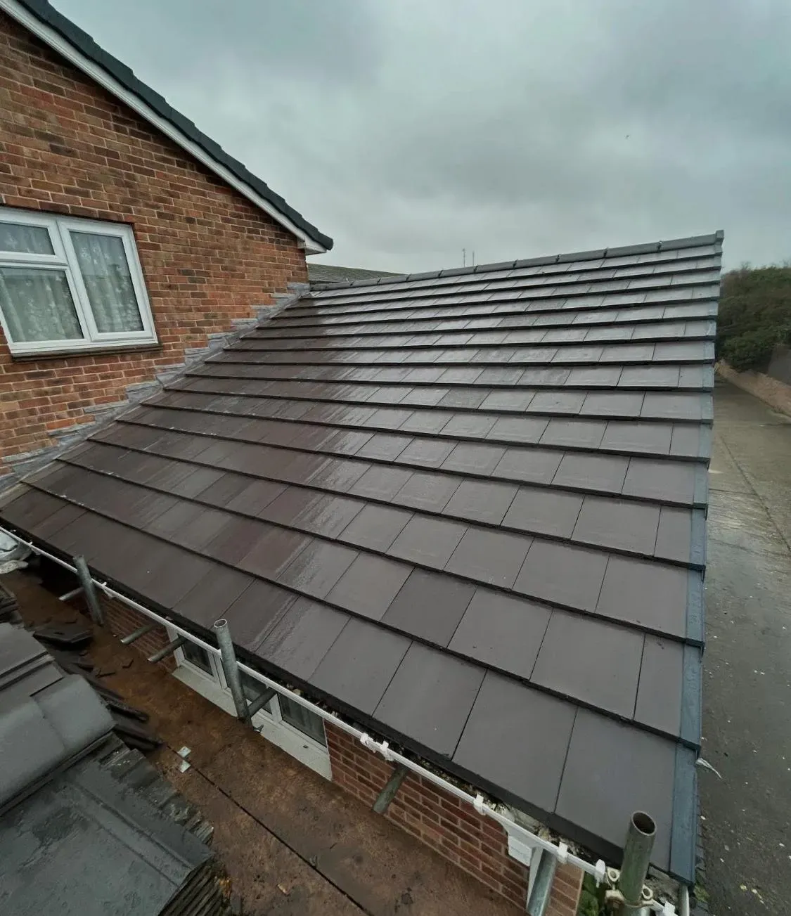 New roof installation with dark grey tiles by Devon and Cornwall Roofing.