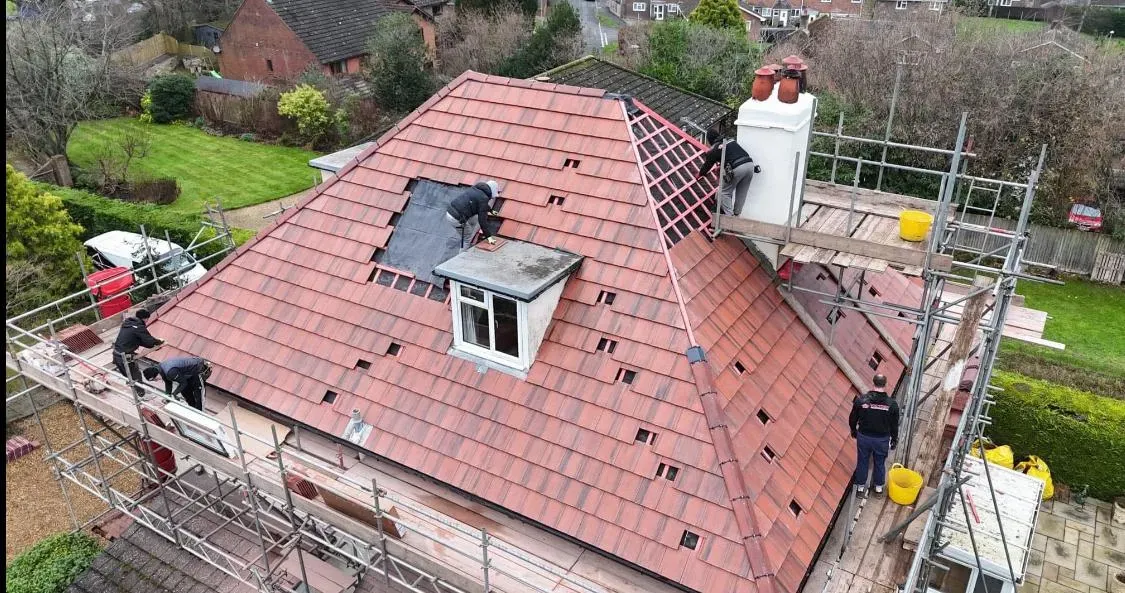 Professional roofers installing new tiles during a complete home re-roofing project